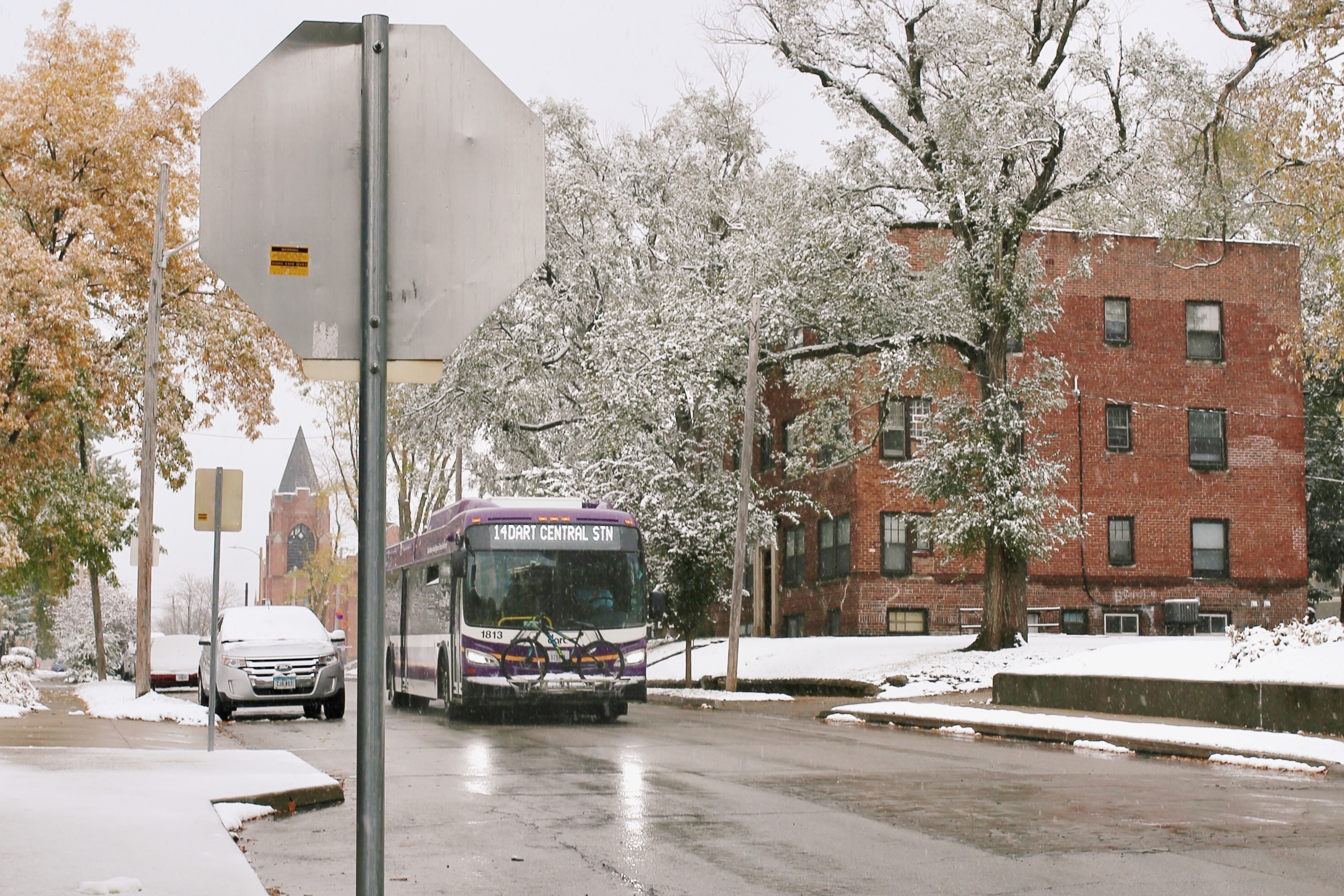 DART bus on route 14 heading towards DART Central Station on a snowy street